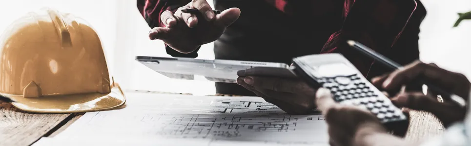 contractors looking over blue prints and the labor hours they need for the project