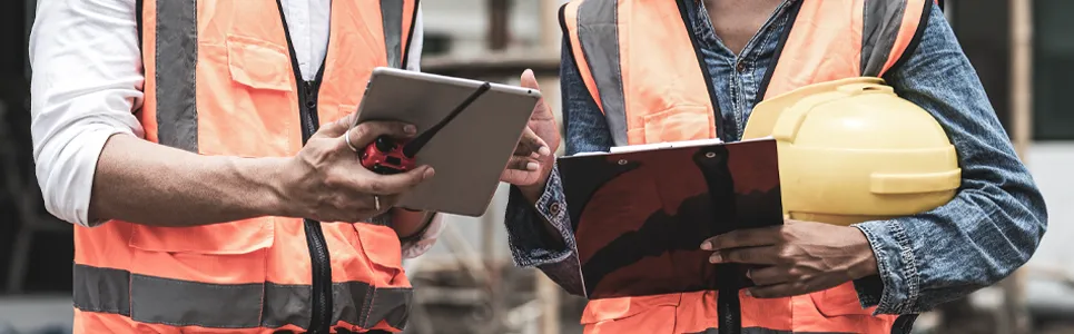 project managers looking at their crew's time on an ipad. 